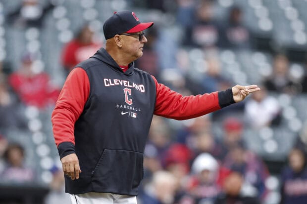 Cleveland Guardians coach giving instructions during a baseball game on the field