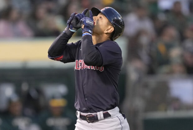 Cleveland Guardians player celebrating during a baseball game in a dark uniform