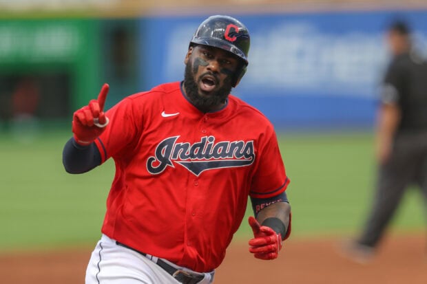 Cleveland Guardians player celebrating during a game wearing a red Indians jersey