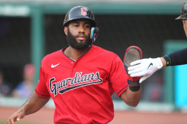 Cleveland Guardians player celebrating with a high five during a baseball game