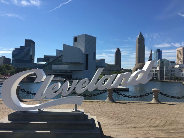 The Cleveland sign with the city skyline in the background on a clear sunny day