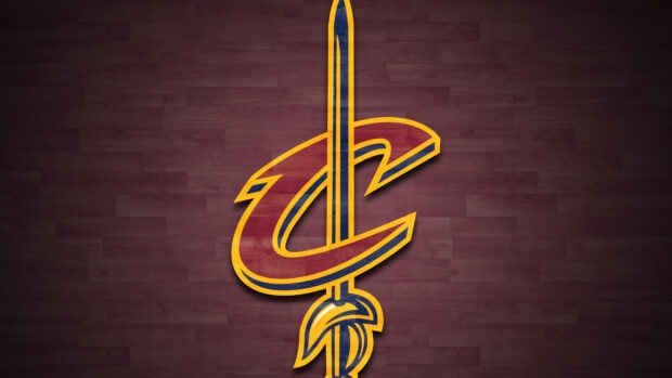 The Cleveland emblem with a sword design on a wooden floor background