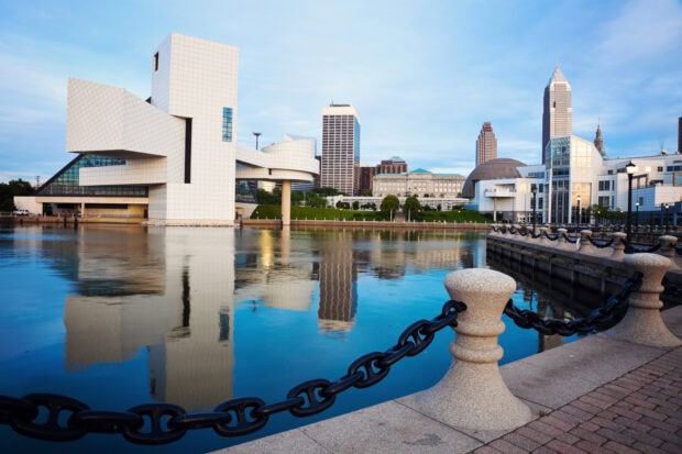 Modern Cleveland skyline with river reflections and unique architecture at sunrise