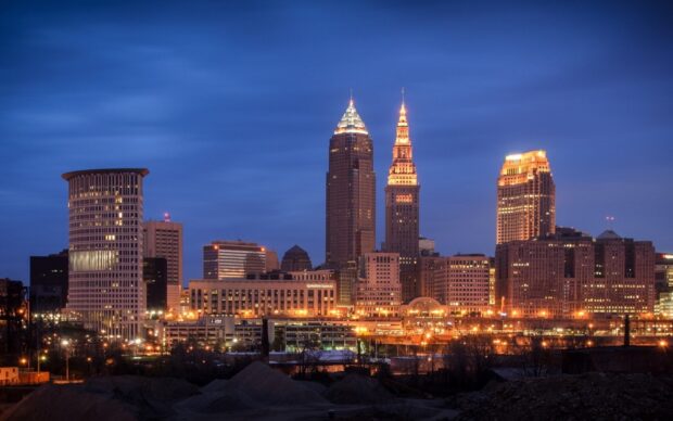 The Cleveland skyline at dusk featuring downtown buildings and city lights