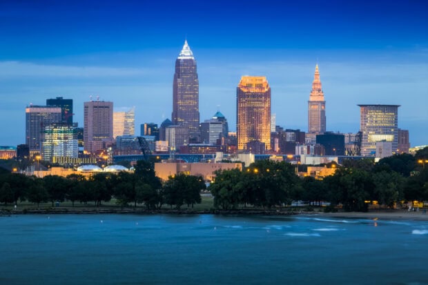 Cleveland city skyline at dusk with illuminated buildings and waterfront view