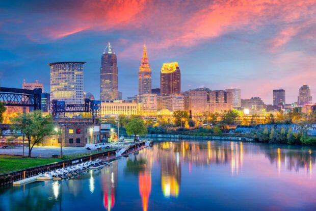 Cleveland city skyline with river reflections during colorful sunset lighting