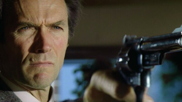 Clint Eastwood aiming a gun in a tense close up scene
