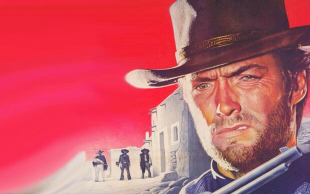 Clint Eastwood in a western setting with a gun and three men standing near old buildings