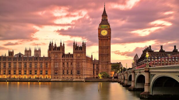 The iconic clock tower shows time during a beautiful sunset over the river Thames