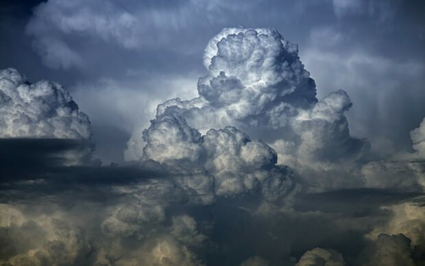 Dark and dramatic clouds forming a towering cloudscape in the sky