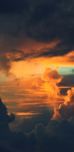 Golden clouds glowing brightly during a dramatic sunset sky