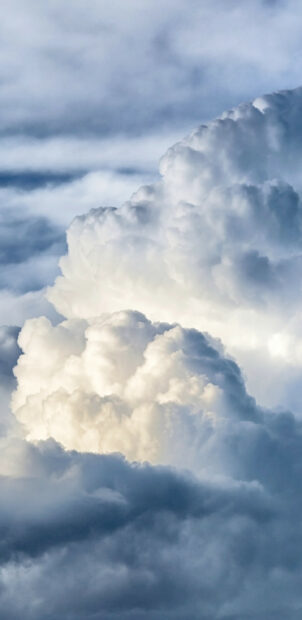 Fluffy clouds forming a peaceful sky scene with various shades of white and gray clouds