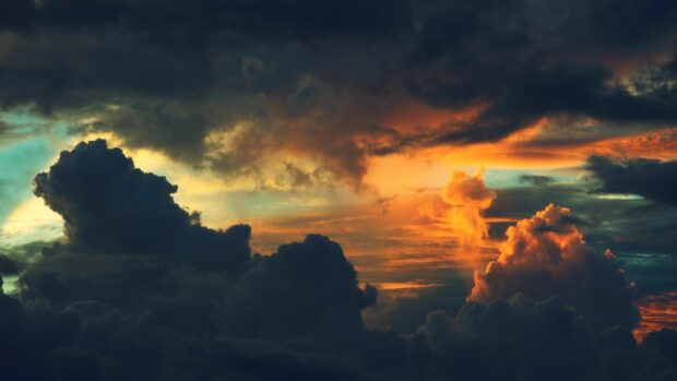 Dark clouds with vibrant sunset colors creating a dramatic cloudscape