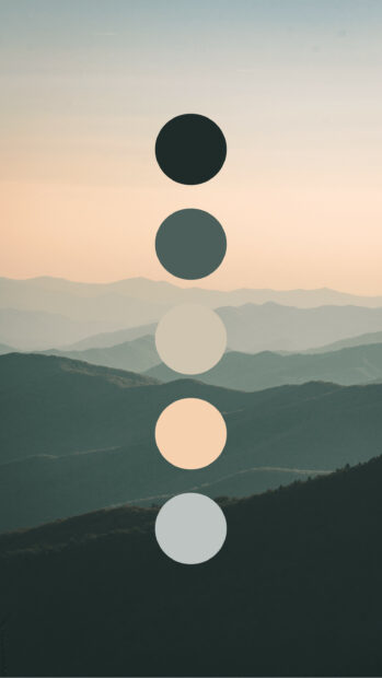 A serene color palette featuring muted green and beige tones over a misty mountain landscape