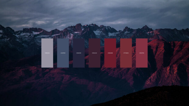 Color palette featuring muted blues and deep reds over a mountain landscape at dusk