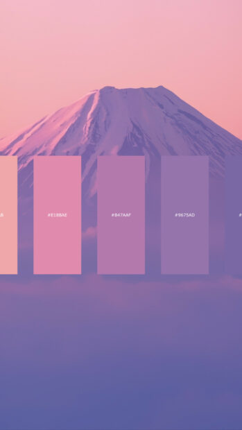 A serene color palette showing pink and purple shades over a mountain landscape at sunset