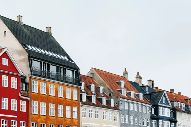Colorful Copenhagen houses with orange roofs and white windows in Denmark