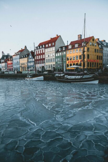 Colorful buildings along the frozen canal in Copenhagen winter scene