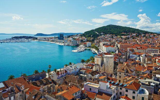A panoramic view of historic rooftops and the coastline in Croatia skyline