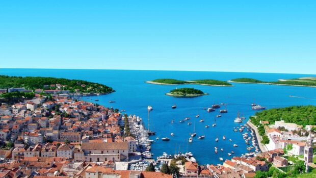 Aerial view of Croatia coastline with historic town and yachts in the harbor
