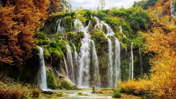 Beautiful waterfall surrounded by autumn trees in Croatia nature