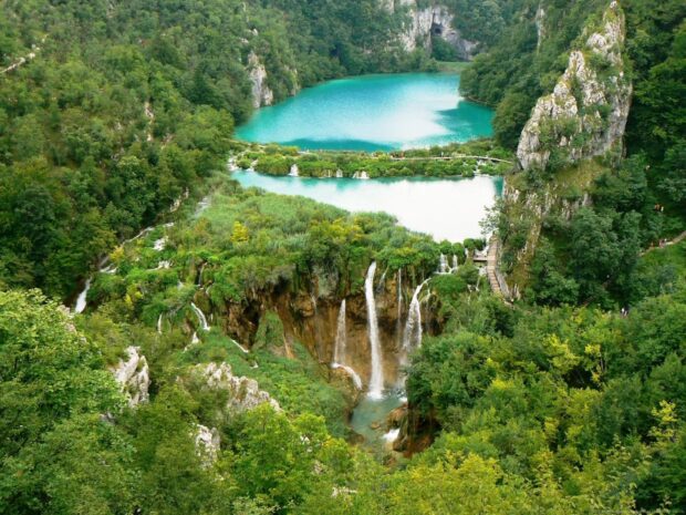 Lush green landscape with waterfalls and turquoise lake in Croatia