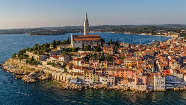 Aerial view of Croatia coastal town with colorful buildings and historic church tower