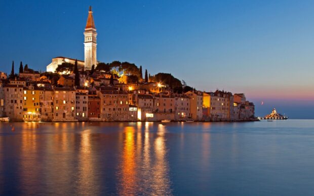 Historic town of Croatia glowing at dusk by the sea
