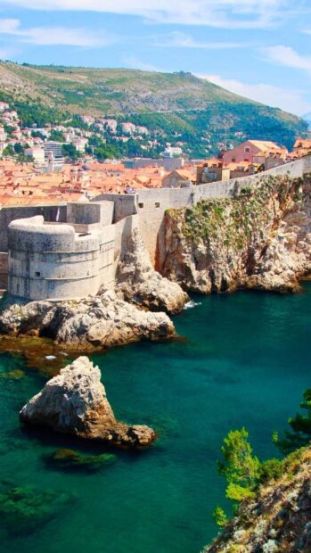 Historic fortress and coastline of Croatia surrounded by clear blue sea and rocky cliffs
