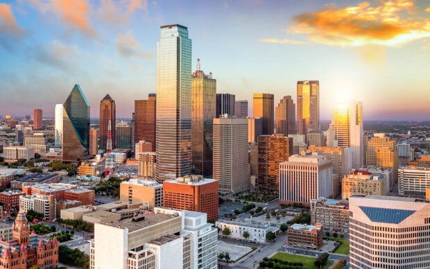 Dallas city skyline featuring modern high rise buildings at sunset in Texas