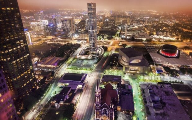 Night view of Dallas Texas cityscape with illuminated buildings and streets
