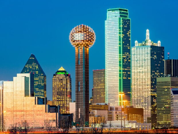The Dallas Texas city skyline featuring iconic Reunion Tower at dusk