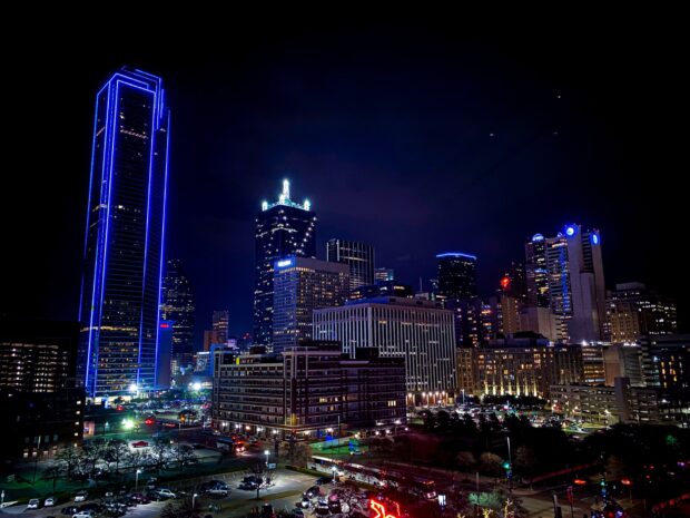 The Dallas Texas skyline at night with illuminated skyscrapers and city lights