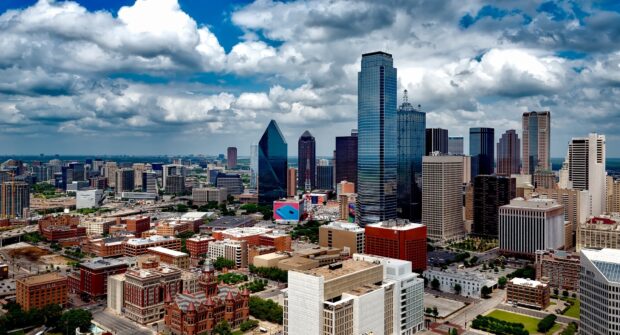Dallas city skyline with tall buildings under cloudy skies in Texas