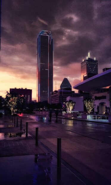 Evening view of Dallas Texas cityscape with illuminated trees and tall buildings
