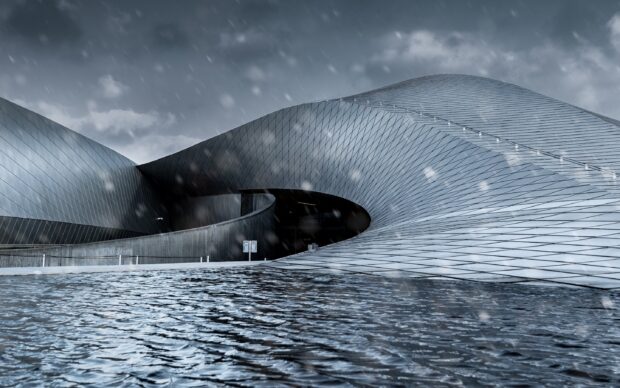 Modern Danish architecture with curved metal roof and water reflection in Denmark