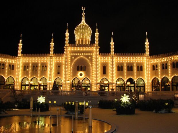 Tivoli Gardens in Denmark illuminated at night with bright decorative lights