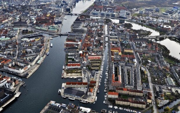 Aerial view of Denmark cityscape with canals boats and historical buildings in an urban area