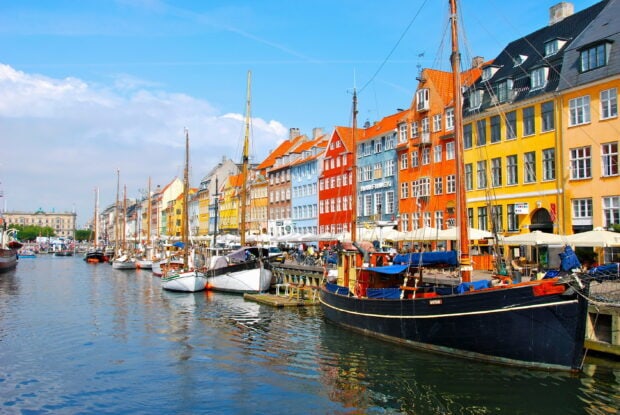 Colorful Copenhagen waterfront with boats and traditional Danish architecture in Denmark