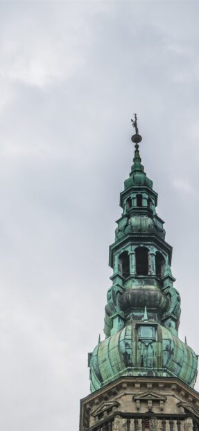 The ornate historic tower with green patina detailing in Denmark architecture