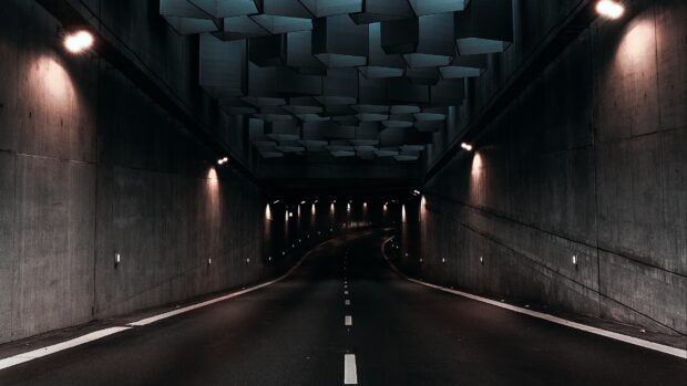 Dark empty road through a modern architectural tunnel in Denmark at night