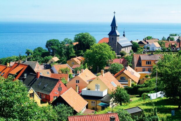 A picturesque Denmark village with traditional houses and a church near the sea