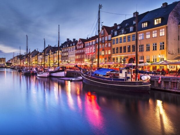 Colorful waterfront buildings and boats at dusk in Denmark canal scene