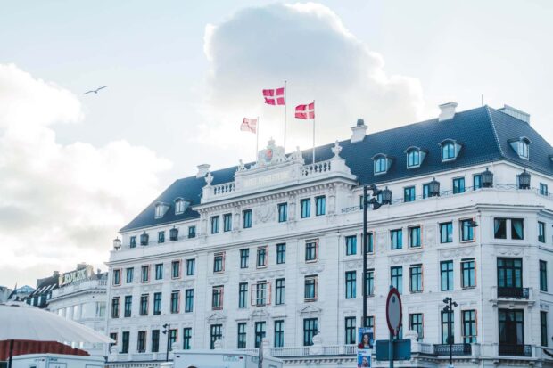 Classic Denmark architecture with flags on top of hotel d angleterre building