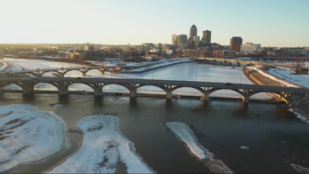 A winter view of Des Moines river with bridges and city skyline in the background