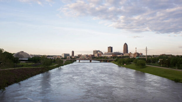 The river flowing through the Des Moines downtown skyline with bridges and greenery