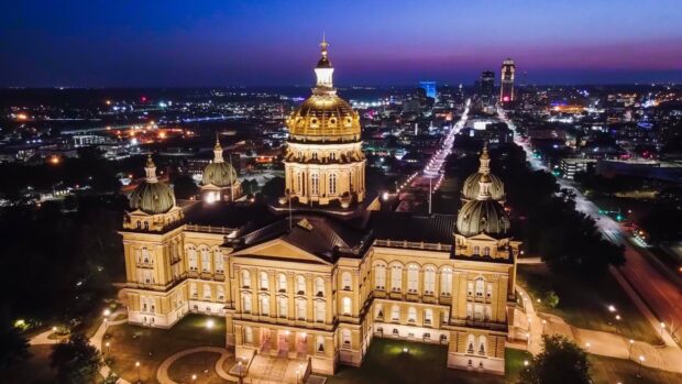 Historic Des Moines capitol building with illuminated domes at night