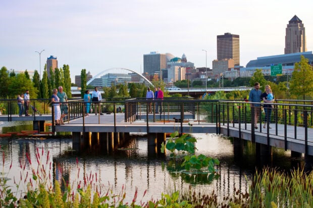 People enjoying the public park and waterfront area in Des Moines cityscape
