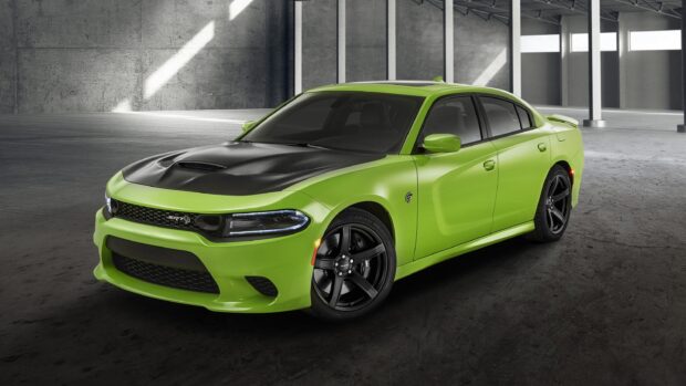 Green Dodge Charger with black hood parked inside an industrial building