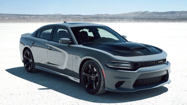 Gray Dodge Charger parked on a dry lake bed showcasing muscle car design